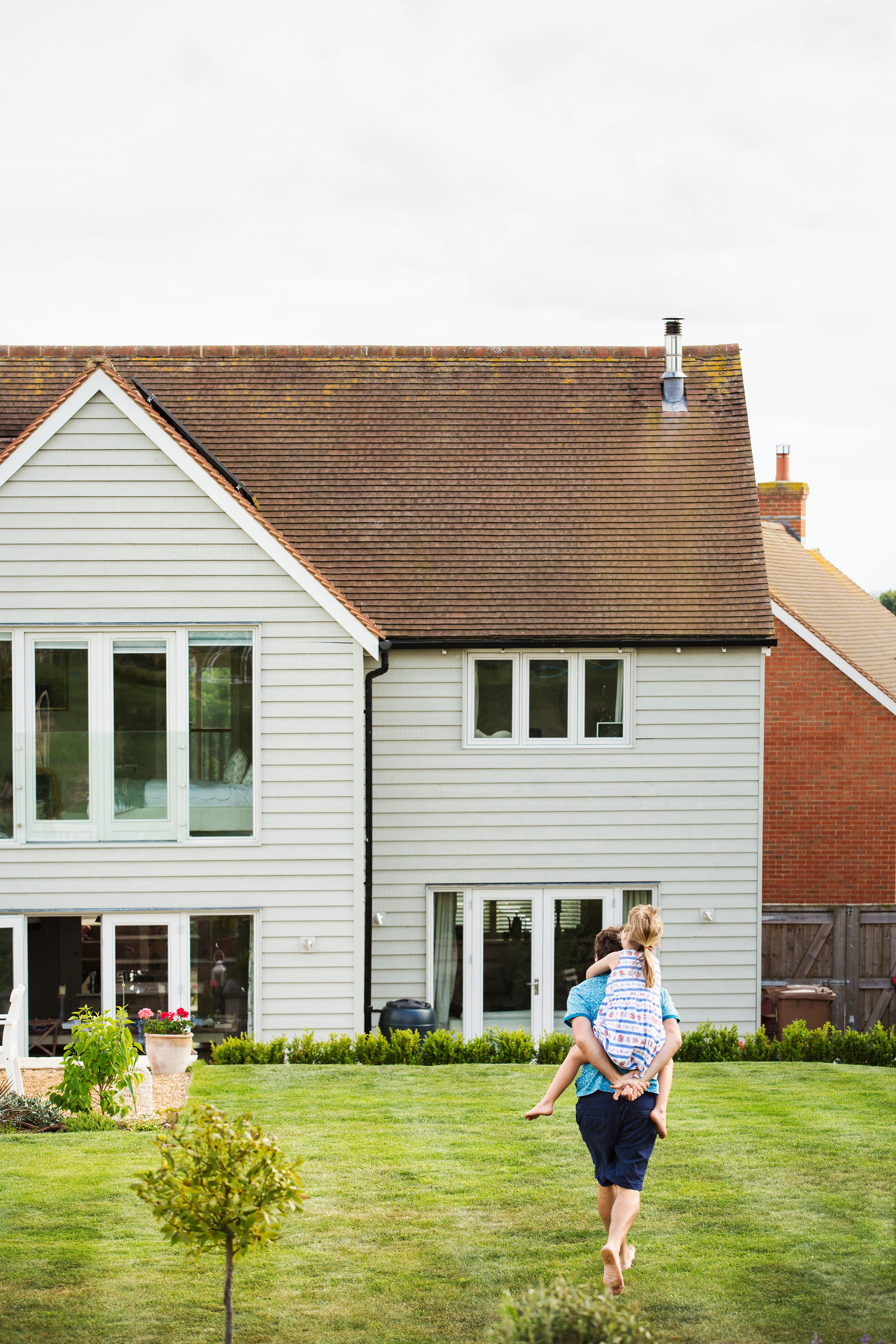 Rear view of a  man walking across a lawn